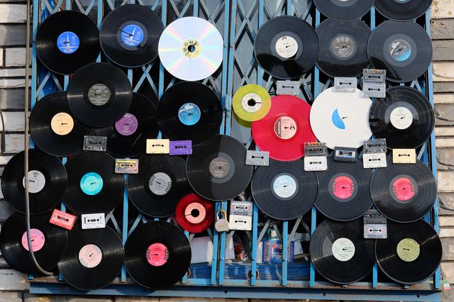 A photo of records hanging on the outside of a store